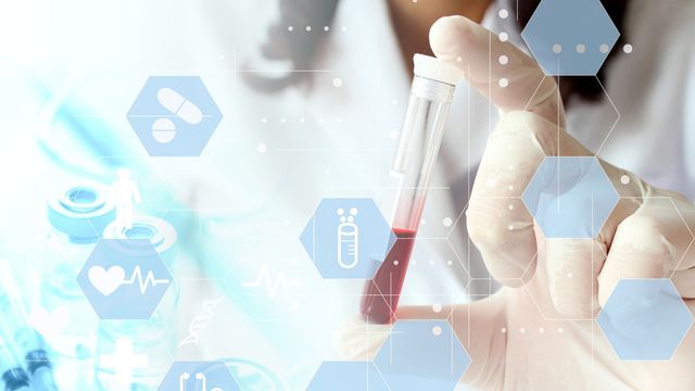 Life science researcher holding a blood sample vial with healthcare icons overlay. 