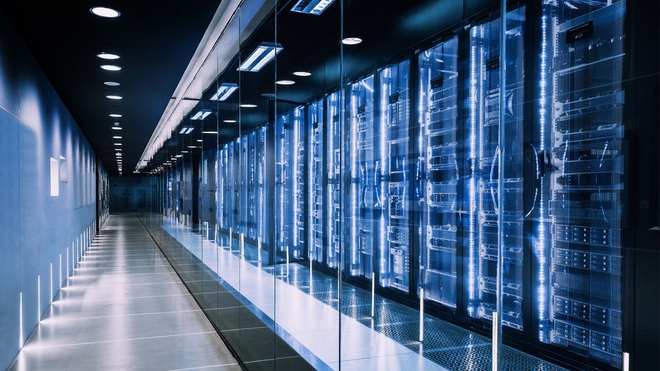 Modern data center with illuminated server racks, representing digital science infrastructure.