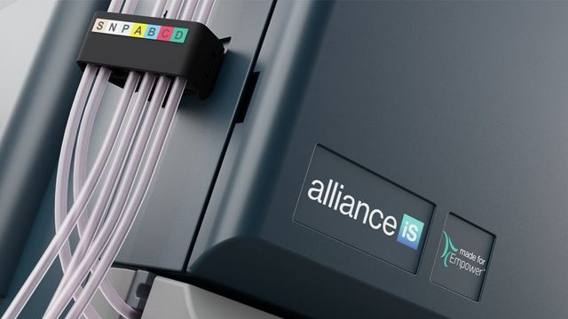 Close-up of lab equipment labeled "alliance iS" with cables marked SNP and letters A–D in colored boxes 